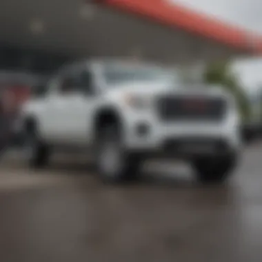 A GMC Sierra 3500HD parked beside a gas station illustrating fuel consumption